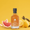 An alluring image of a glass bottle containing zesty French Lemon Grapefruit Vinegar. The invigorating citrus vinegar is a delightful blend of tangy lemons and juicy grapefruits, meticulously crafted using traditional French methods. The bottle showcases the luminous, golden-hued liquid, exuding a fresh and uplifting aroma. The label on the bottle features an elegant design with hints of citrus fruits, evoking the essence of sunny orchards. This tantalizing Lemon Grapefruit Vinegar promises to add a burst of vibrant flavor to your culinary creations, making it a must-have condiment for gourmet enthusiasts. A taste of sunny citrus captured in a premium French vinegar.