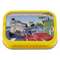 This image features a tin of "Sardines au Citron Confit," surrounded by a bright yellow border. The illustration on the tin is vibrant and playful, depicting an adventurous scene.

In the foreground, there's an old-fashioned, open-top vehicle with three characters enjoying a drive. The driver, wearing a beret and a scarf, seems to be in mid-conversation with his passengers. Beside him is a figure that resembles a smiling sardine, anthropomorphized with arms and a face, wearing goggles and a scarf, adding a whimsical touch. The third character is a cheerful woman in the back seat, who seems to be enjoying the ride, her hair flowing in the wind.

The background shows a coastal road that curves along the picturesque landscape of the French Riviera, with a lighthouse in the distance and the blue sea extending to the horizon. A road sign reads "NT MENTON," suggesting the region known for its lemons, which ties in with the citron confit (pickled lemon) flavor of the sardines.

The product name, "SARDINES AU CITRON CONFIT," is highlighted at the top of the tin. Below the illustration, the description further clarifies the contents as "Sardines with pickled lemon." The weights are specified as Net wt. 4.05 oz (115 g) and Drained wt. 2.29 oz (65 g).

The overall design of the tin conveys a sense of fun and adventure, evoking the fresh, citrusy flavors of the Mediterranean and suggesting that the sardines are prepared with the tangy and aromatic pickled lemons of Menton, a town renowned for its lemons.