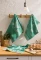 Jacquard cotton tea towel featuring a hen and baby chicks in a rustic countryside design with soft green tones.