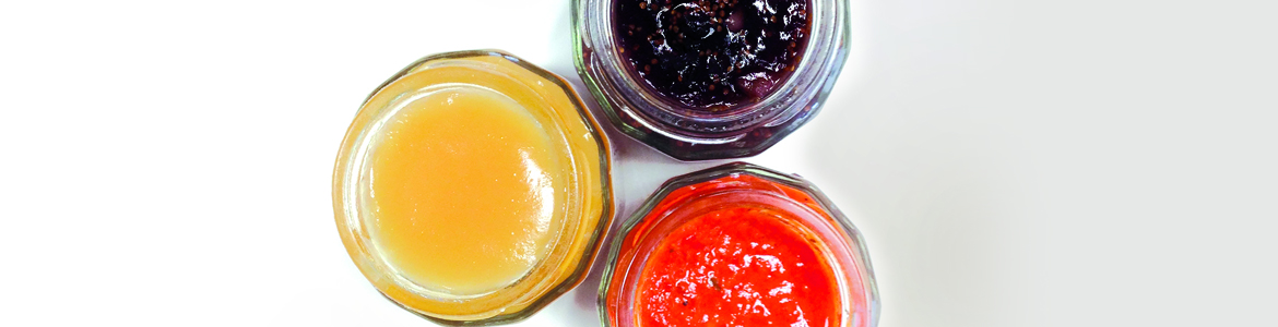 beauty shot of three glass jars of various confits