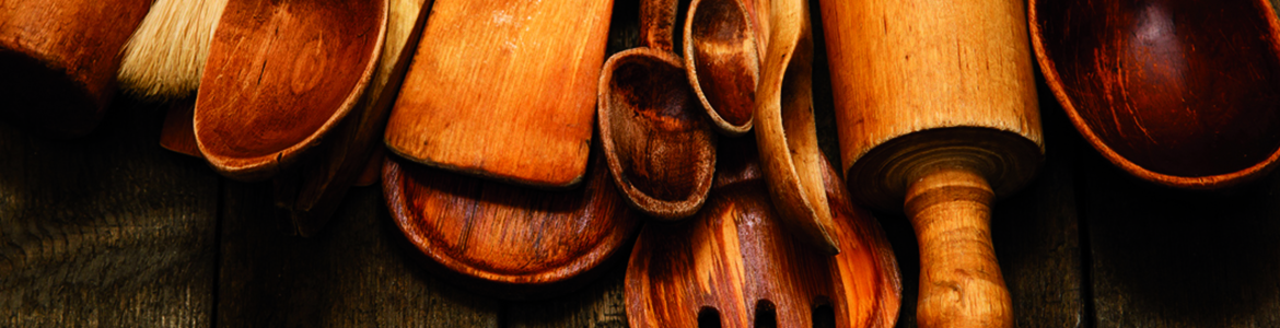 several wooden kitchen utensils including spoons spatulas and rolling pins