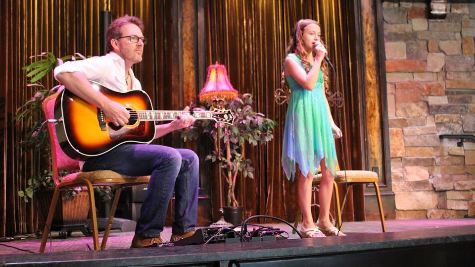 a man and woman playing guitar