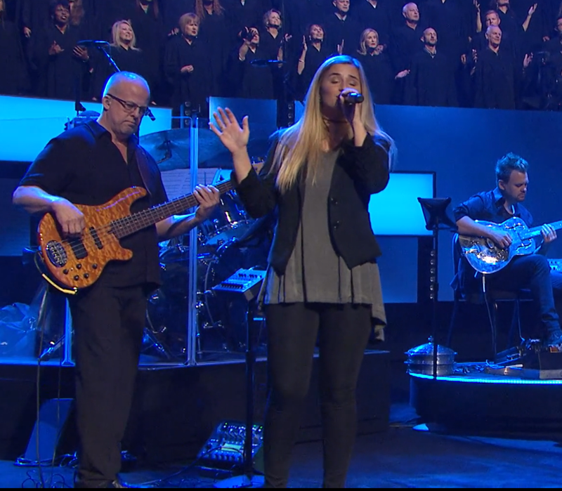a man and woman singing on stage