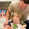 Munchkin Gift Box in Background with Man and Baby