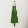 Personalized Canvas Apron in Green hanging on wooden hook
