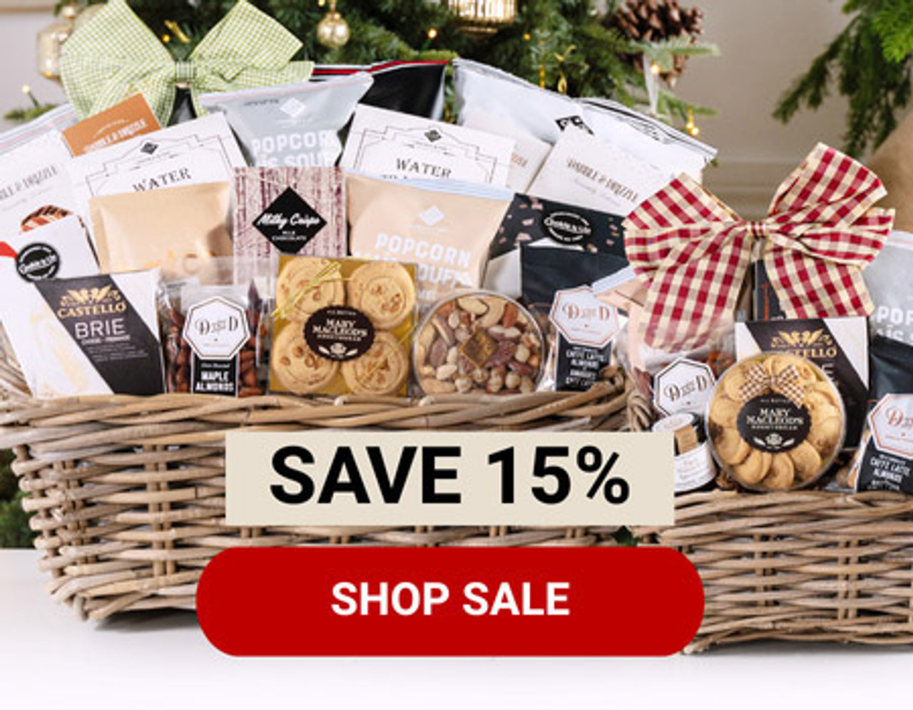 A photo of two gift baskets in front of a Christmas setting