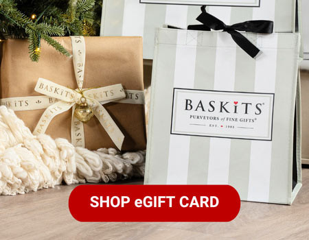 A photo of a gift basket in front of a Christmas tree