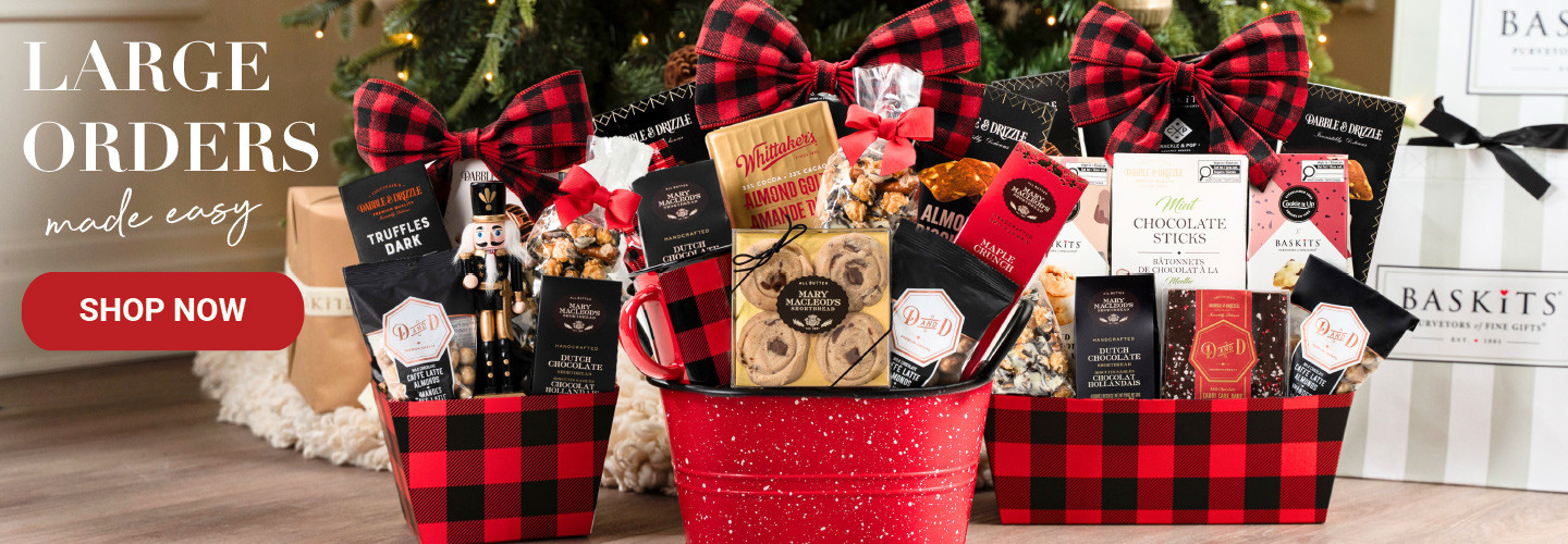 A photo of three gift baskets in front of a Christmas tree