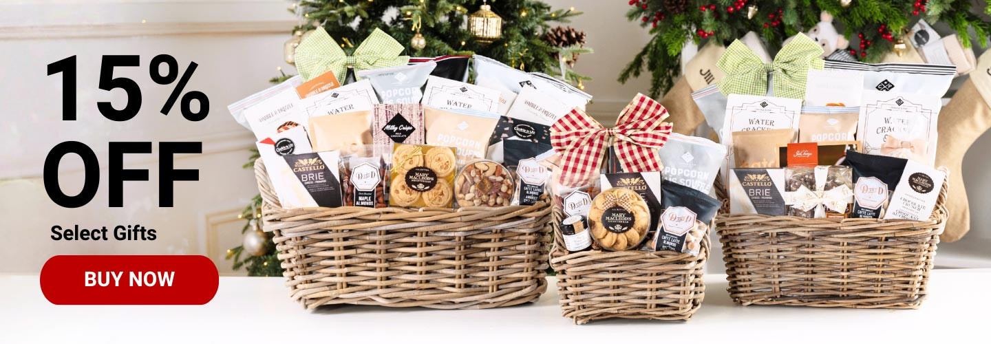 A photo of three gift baskets in front of a Christmas setting