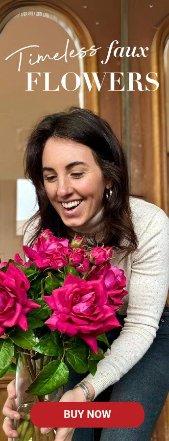 A woman holding faux flowers