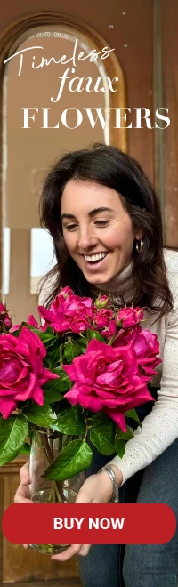 A woman holding faux flowers