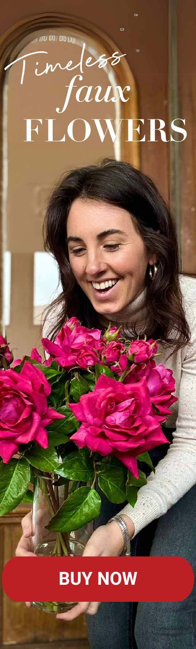 A woman holding faux flowers