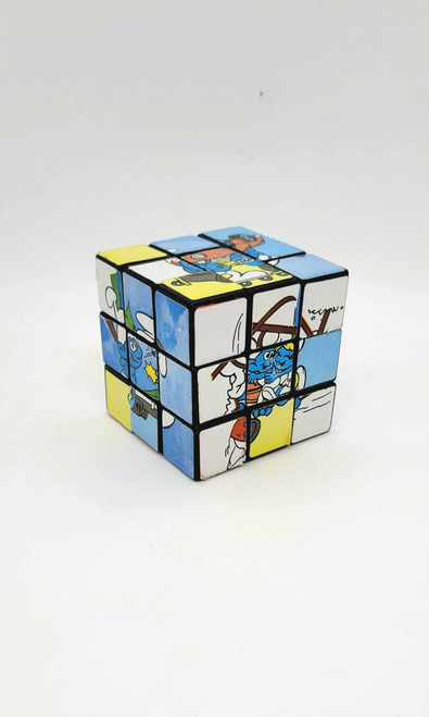 Smurfs Rubik's Cube, a colorful puzzle toy featuring characters from the Smurfs franchise on a standard 3x3 cube.