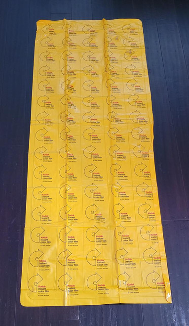 Kodak Instant Color Film Inflatable Pool Raft, yellow inflatable pool float with Kodak logo and colorful film pattern design, suitable for swimming or pool parties.