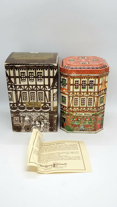 D.E. Wolfgang Candy Bavarian Village Canister #02-95 Market Square Tin, decorative collectible tins featuring detailed illustrations of Bavarian village scenes with market square and flower shop motifs.