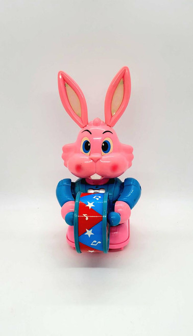BOTOY Plastic Battery Operated Bunny Drumming, pink bunny toy with large ears holding a colorful drum.