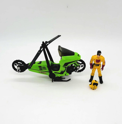 Kenner M.A.S.K. 1985 Condor Series 1 Vehicle, a green and black toy motorcycle with a futuristic design, alongside a yellow action figure in a racing suit with helmet and goggles, on a plain white background.