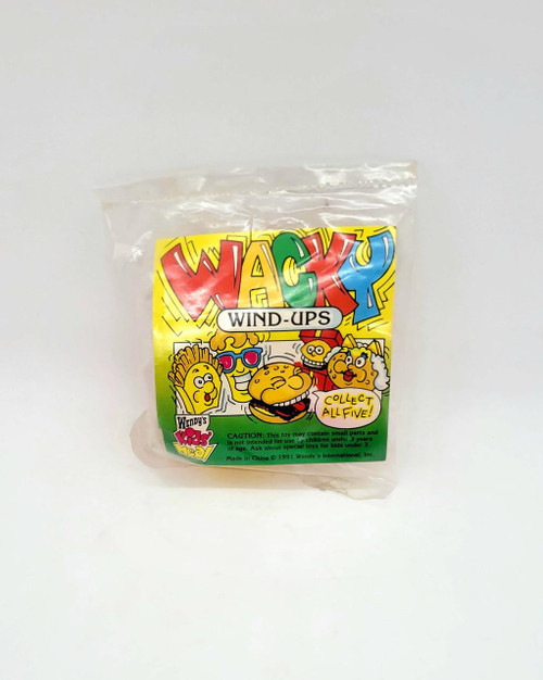 Wendy's Kids Meal Toy 1991 Wacky Wind-Ups Christmas Gift Hamburger In Box, colorful vintage toy in clear plastic packaging with cartoon characters and fun text.
