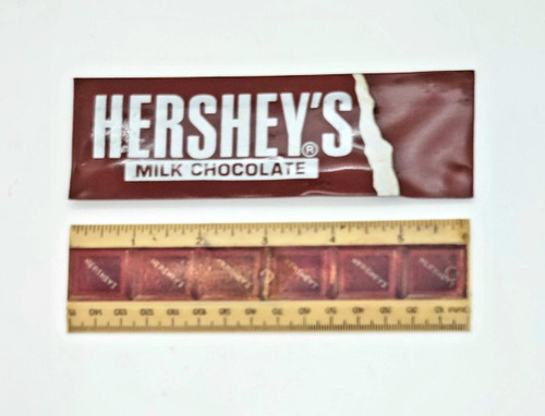 Hershey's Milk Chocolate 6-inch Plastic Ruler, measuring tool with Hershey's chocolate packaging in the background.
