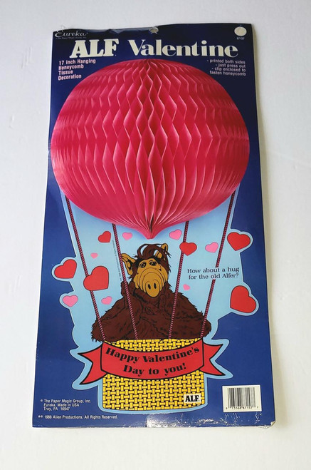 ALF 1988 Valentine 17 Inch Hanging Honeycomb Tissue Decoration, red honeycomb tissue ball with cartoon ALF character in a hot air balloon basket adorned with hearts, festive Valentine's Day theme.