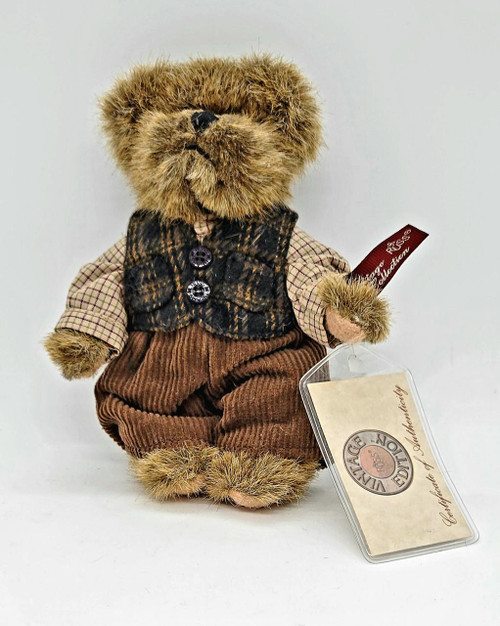 Russ Berrie & Co Russ Berrie Vintage Edition #44703 Gordon Teddy Bear, a vintage plush teddy bear with a fluffy, light brown fur, dressed in a plaid shirt, plaid vest, and brown corduroy pants, with a red tag attached to its arm.