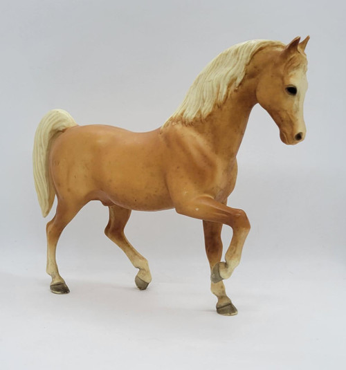 BREYER Vintage BREYER Palomino Arabian Stallion, collectible figurine of a golden-hued horse with a cream-colored mane and tail, captured in a lifelike pose.