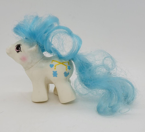 My Little Pony 1988 Dangles, vintage toy pony with light blue curly mane and tail, white body with colorful symbol markings, pink eye makeup, and a cute face.