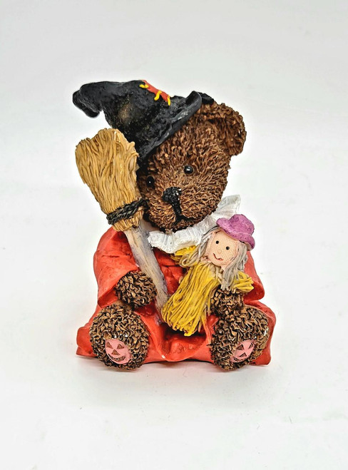 Unknown Halloween Bear as Witch Resin Figurine, a detailed bear figurine dressed as a witch holding a broomstick and a doll, with pumpkin details on its paws.