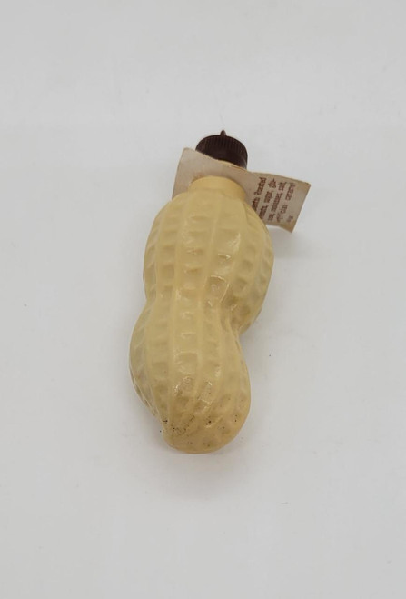 Unknown Vintage Plastic Peanut Candy Container, antique cream-colored plastic peanut-shaped container with a brown cap and vintage label.
