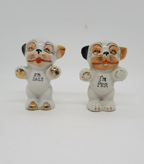 Bonzo Vintage Bonzo Gold Paws Dog Salt and Pepper Shakers, made in Japan, featuring ceramic dog figurines with gold details and humorous inscriptions 'I'M SALT' and 'I'M PER'.