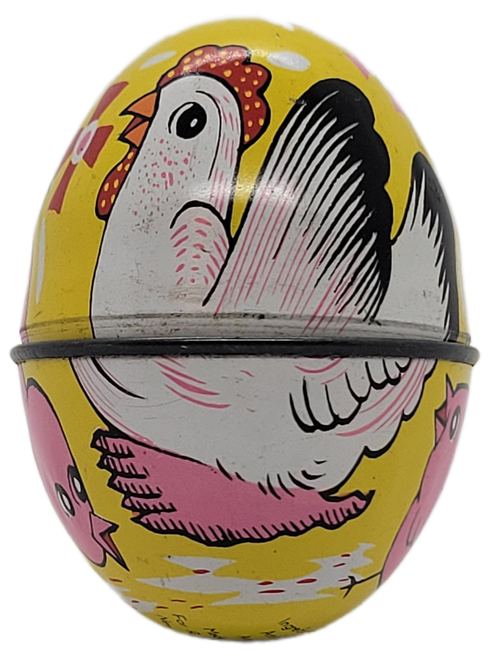 Vintage yellow tin Easter egg featuring a white hen sitting on a pink nest