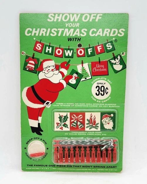 Associated Match Companies Vintage 1964 Show Offs 25 Christmas Card Display System, vintage holiday Christmas card display with Santa Claus graphic and red and green Christmas themed decorations.
