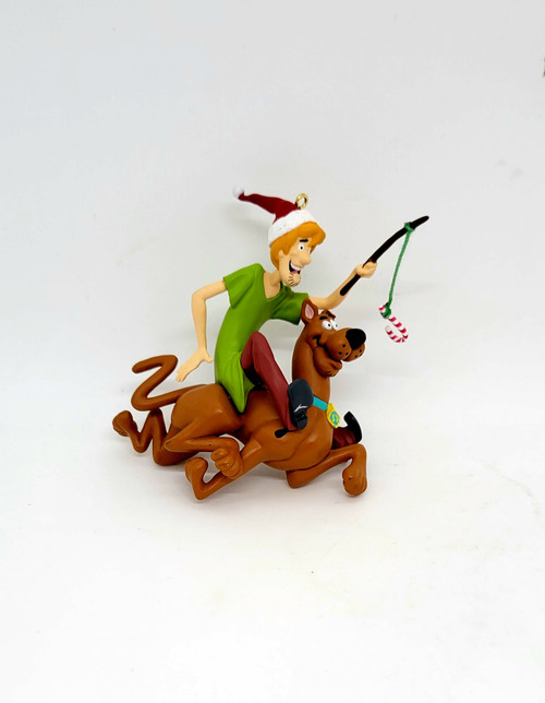 Hallmark Keepsake ornament of Scooby-Doo and Shaggy produced in 2000. The ornament features Shaggy riding Scooby-Doo using a candy cane on a string to entice Scooby to run.