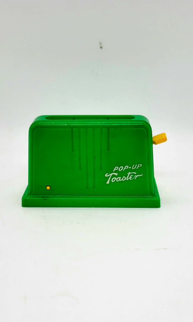 Vintage plastic green toy Pop-Up Toaster with yellow handle. The small single toaster stands 2.25 inches high and 4 inches long.  Press down yellow handle and slide to the side to lock in place.