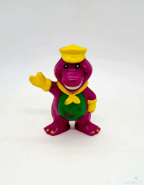 Barney and Friends plastic 2.75-inch tall figure of Train Conductor Barney.  The hard plastic figure features Barney wearing a yellow conductor hat, gloves and scarf.