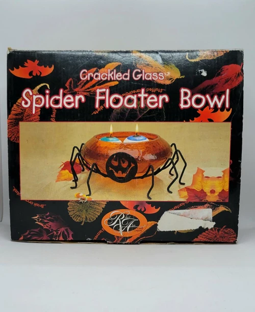 Vintage Robert Alan Candle Co. Crackled Glass Spider Floater Bowl Halloween Decoration, black and orange glass bowl with spider design, Halloween themed candles and fall leaves on packaging.