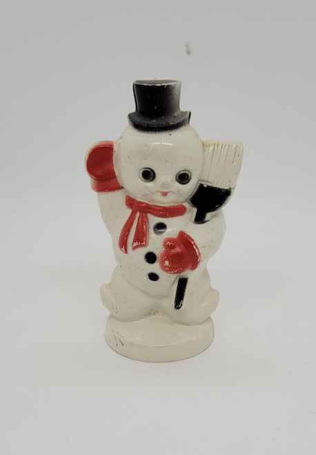 Vintage hard plastic snowman figure that stands 3.75-inches tall.  The figure is wearing red gloves and scarf with his black hat and broom. 
