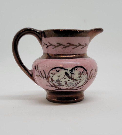 Pavelco Hand Painted 2" Ceramic Creamer with Handle, pink and brown ceramic pitcher featuring mountain and landscape design with trees and birds.