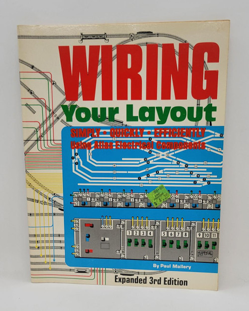 Wiring Your Layout, a paperback book cover from February 1988, featuring diagrams and illustrations of electrical components and wiring setups with bold red, green, and blue text.