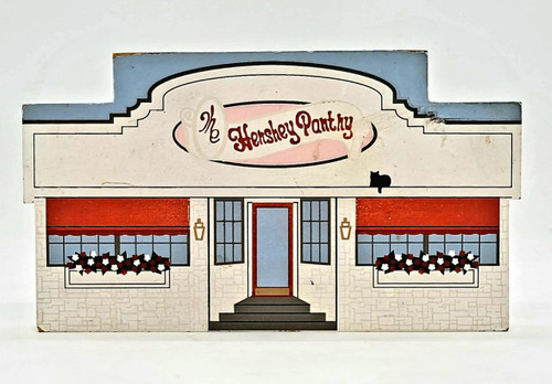 The Cat's Meow 1995 - Hershey Pantry, decorative vintage cardboard box depicting a storefront with red and white flowers in window boxes and a large sign labeled Hershey Pantry with a silhouette of a black cat.
