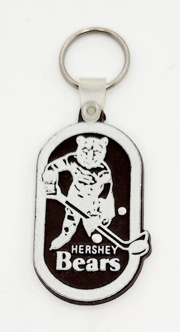 Hershey Bears AHL Hershey Bears Rubber Keychain, keychain featuring a bear playing hockey with a stick and puck.
