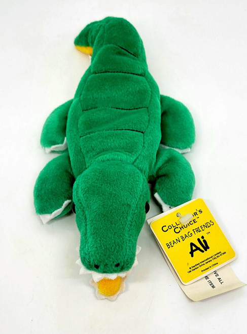 Dan-Dee Collector's Choice Bean Bag Friends Ali the Alligator plush toy, soft green stuffed animal with a yellow snout, white teeth, and black eyes, lying on a white surface.