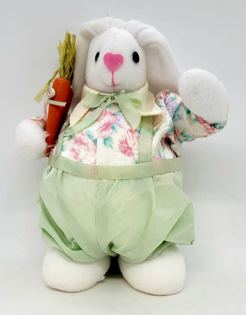 Unbranded Easter Bunny 8" Table Top Decor, plush white bunny wearing pastel floral dress and green pants, holding a small carrot with a straw top.