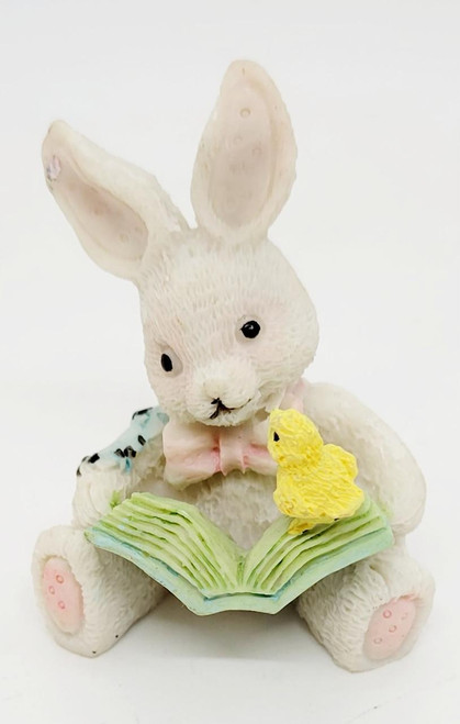 Unknown White With Patchwork Bunny Reading Book 2.25" Resin Figurine, adorable white bunny with large ears, holding a yellow chick and a pastel-colored open book.