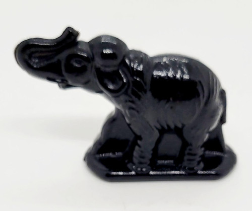 Unknown Small Black Molded Elephant Figurine, a detailed black miniature elephant sculpture with intricate carvings on its surface.