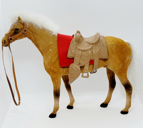Unknown Caramel Colored Felt Covered Horse Figure with Saddle, toy horse with saddle and bridle, plush and plastic materials, realistic horse design.