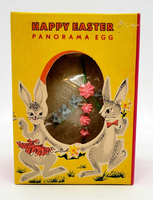 R. L. Alberts & Son Vintage 1960's Happy Easter Panorama Egg, still sealed in a colorful yellow box with illustrations of rabbits, featuring pink and blue flower decorations inside.