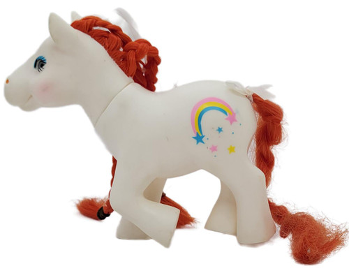 Gi-Go Tootsie Pose Glass Eye Insert Pony White With Orange Hair Rainbow With Shooting Star, a white plush pony toy with orange yarn hair, rainbow and star design on its side, and decorative bows on its tail and mane.