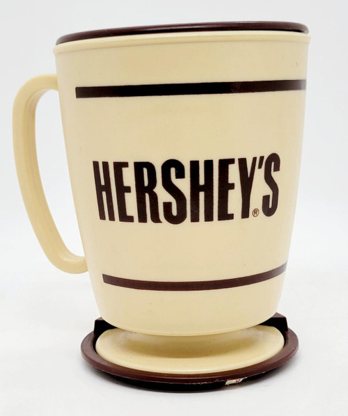 Hershey's Vintage Whirley Industries Hershey's Foods Travel Mug, retro cream-colored ceramic mug with brown lettering and decorative stripes, with matching coaster.
