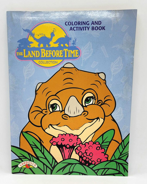 The Land Before Time Coloring and Activity Book (Cera) - 1997, front cover illustration of a cartoon dinosaur with green eyes and a smiling expression, surrounded by pink flowers and green leaves.